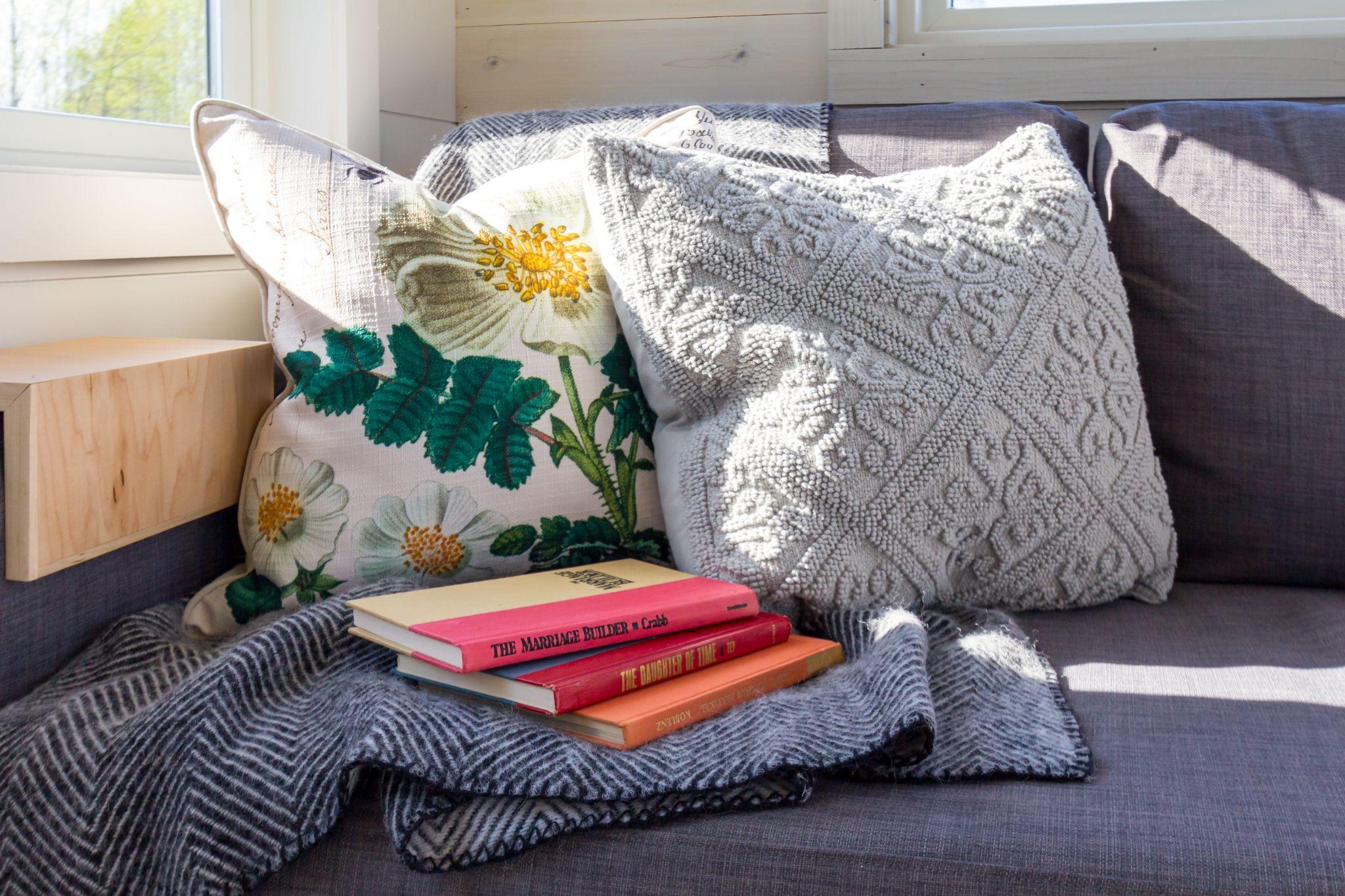 add textured pillow and throw blanket to make sitting area feel cozy
